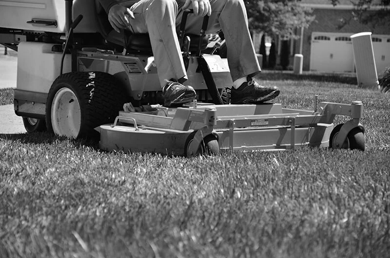 Man operating a commercial lawn mower for commercial lawn mowing