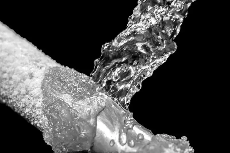 Water spraying out of icey frozen pipes