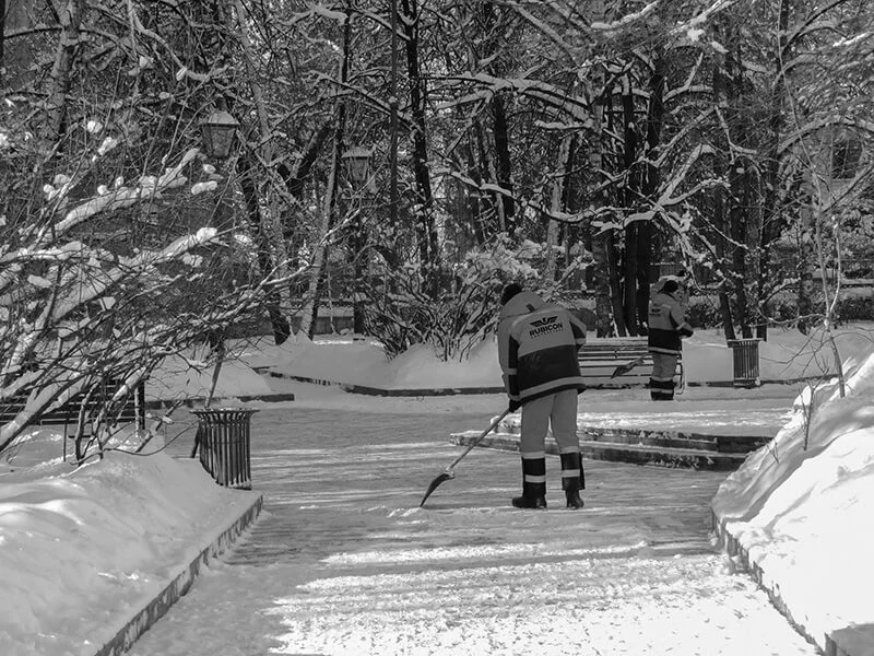 Rubicon snow services: snow warrior shoveling snow by hand on walkway